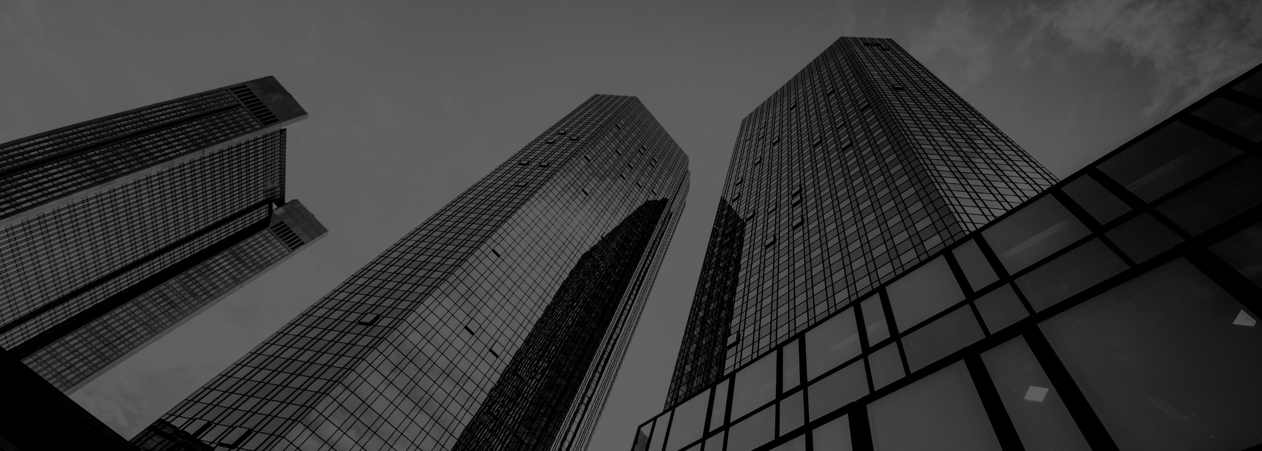 Tops of skyscrapers with exterior windoews viewed from street level