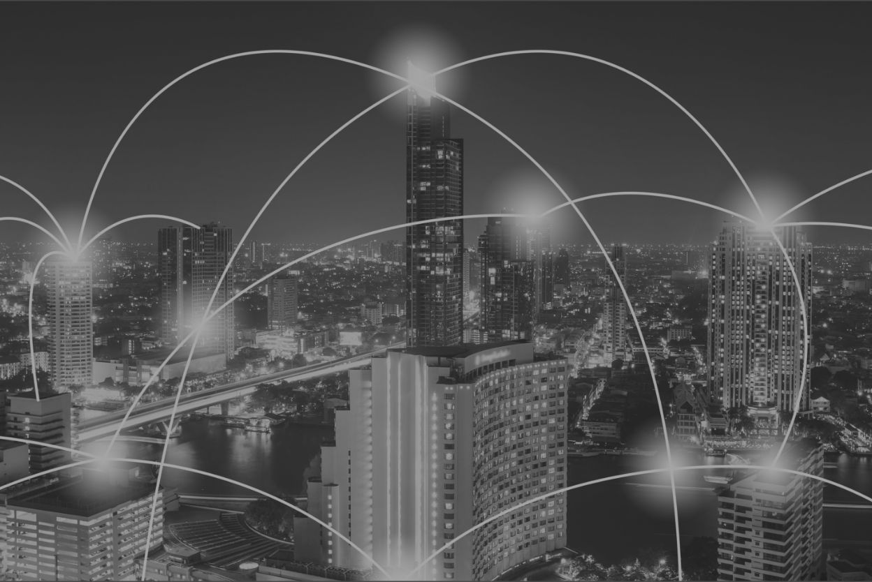 Upward view of modern glass skyscrapers with abstract curved white lines overlayed on a green-tinted background